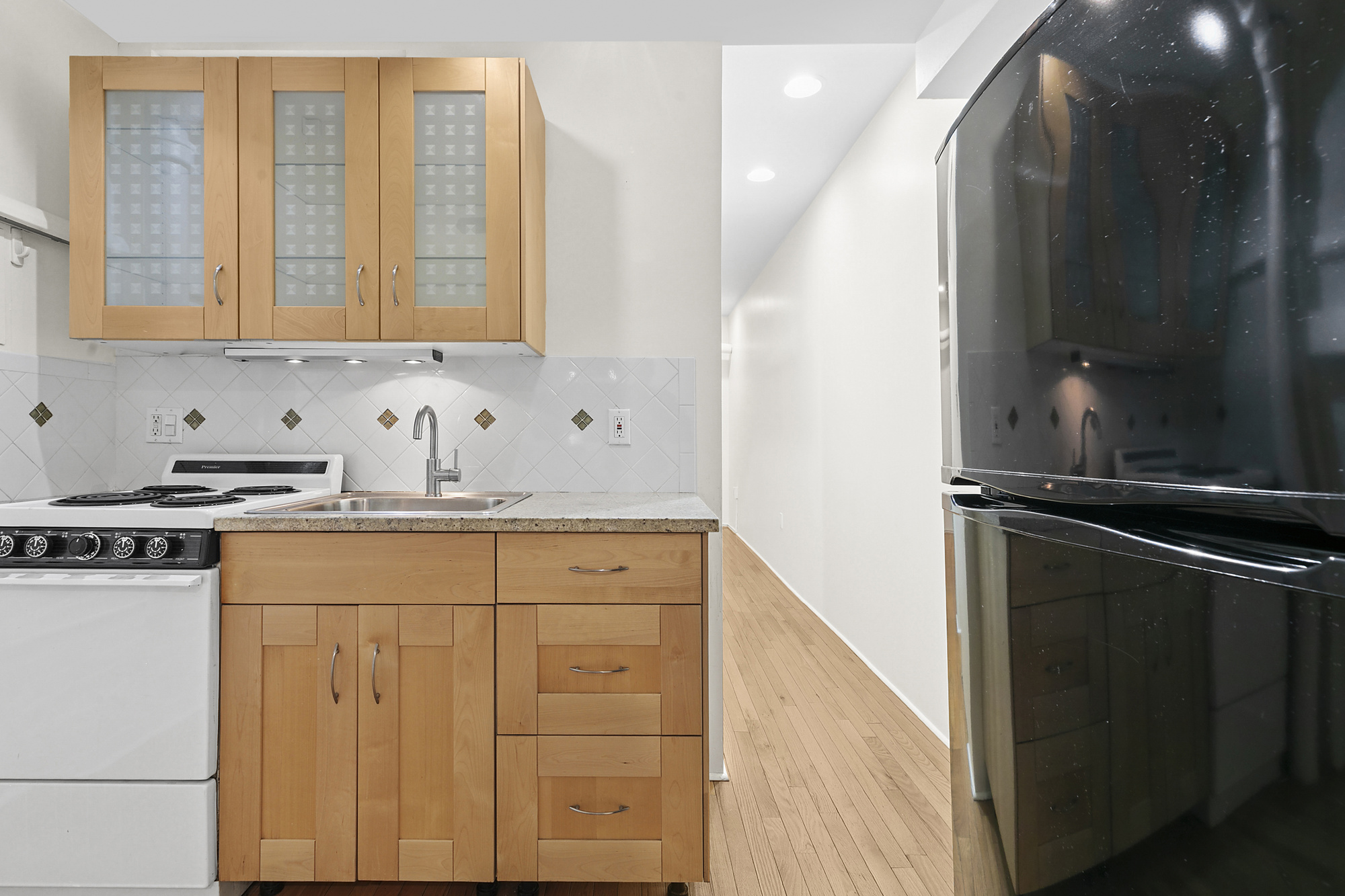 140 West 10th Street, Unit BTE Manhattan, NY 10014 - Photo 2 of 12 a kitchen with granite countertop a sink and a stove