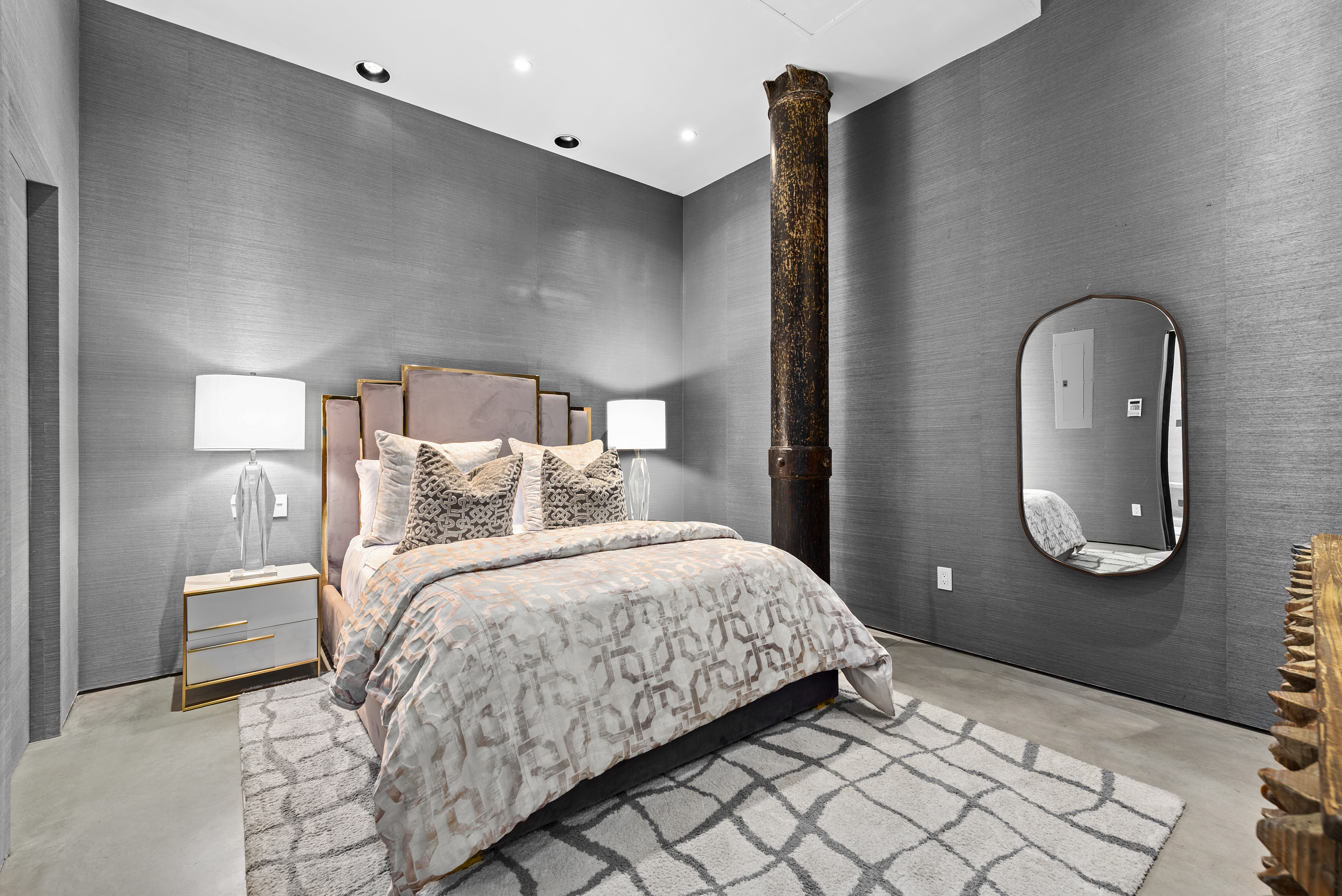 10 Bleecker Street, Unit 1B Manhattan, NY 10012 - Photo 5 of 16 a bedroom with a bed and a mirror