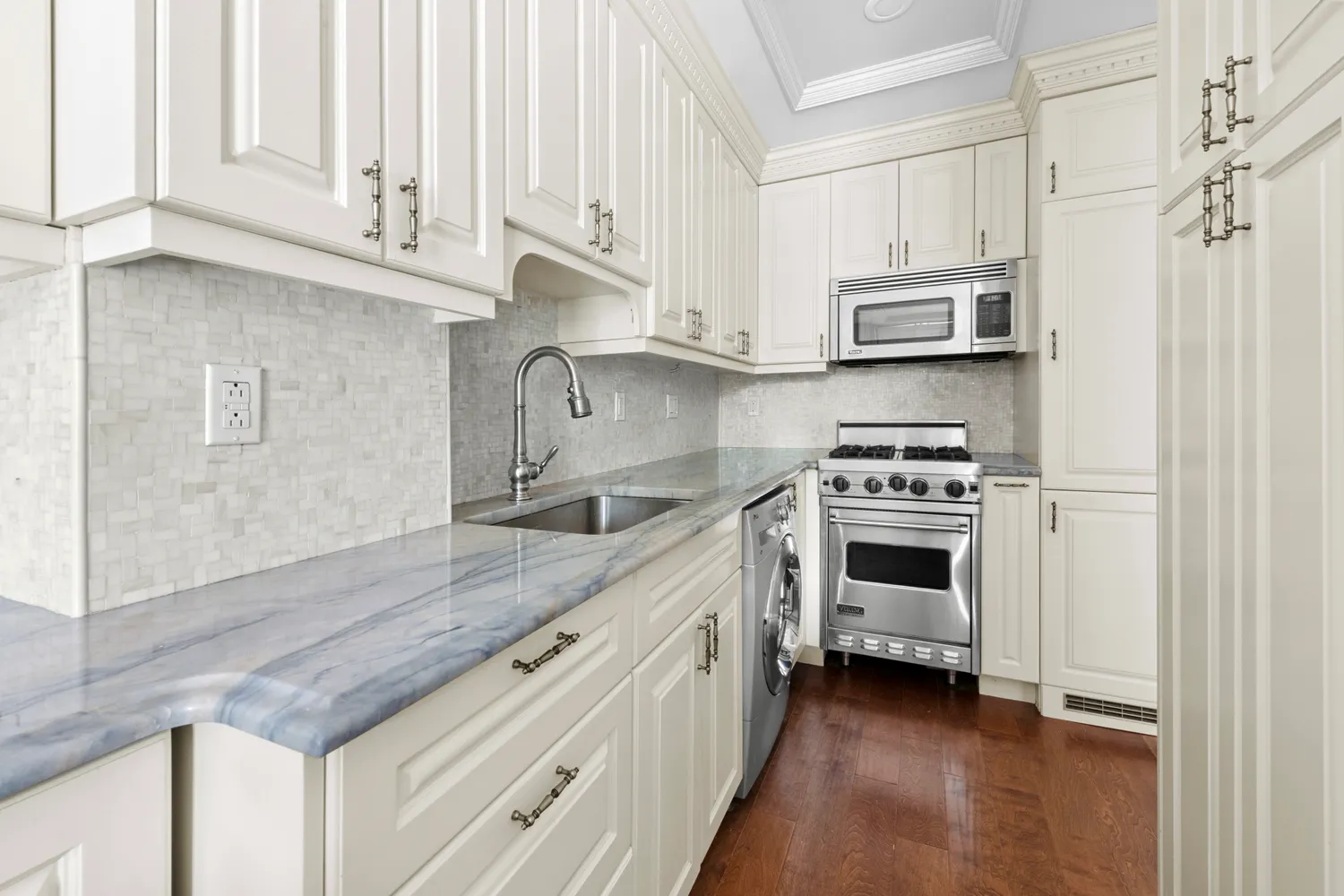 a kitchen with stainless steel appliances white cabinets and a sink