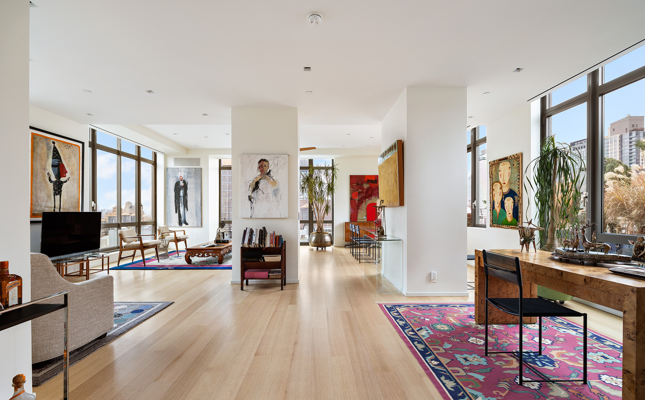 a living room with furniture a flat screen tv and large window