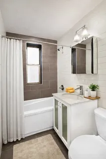 a bathroom with a sink a toilet and bathtub