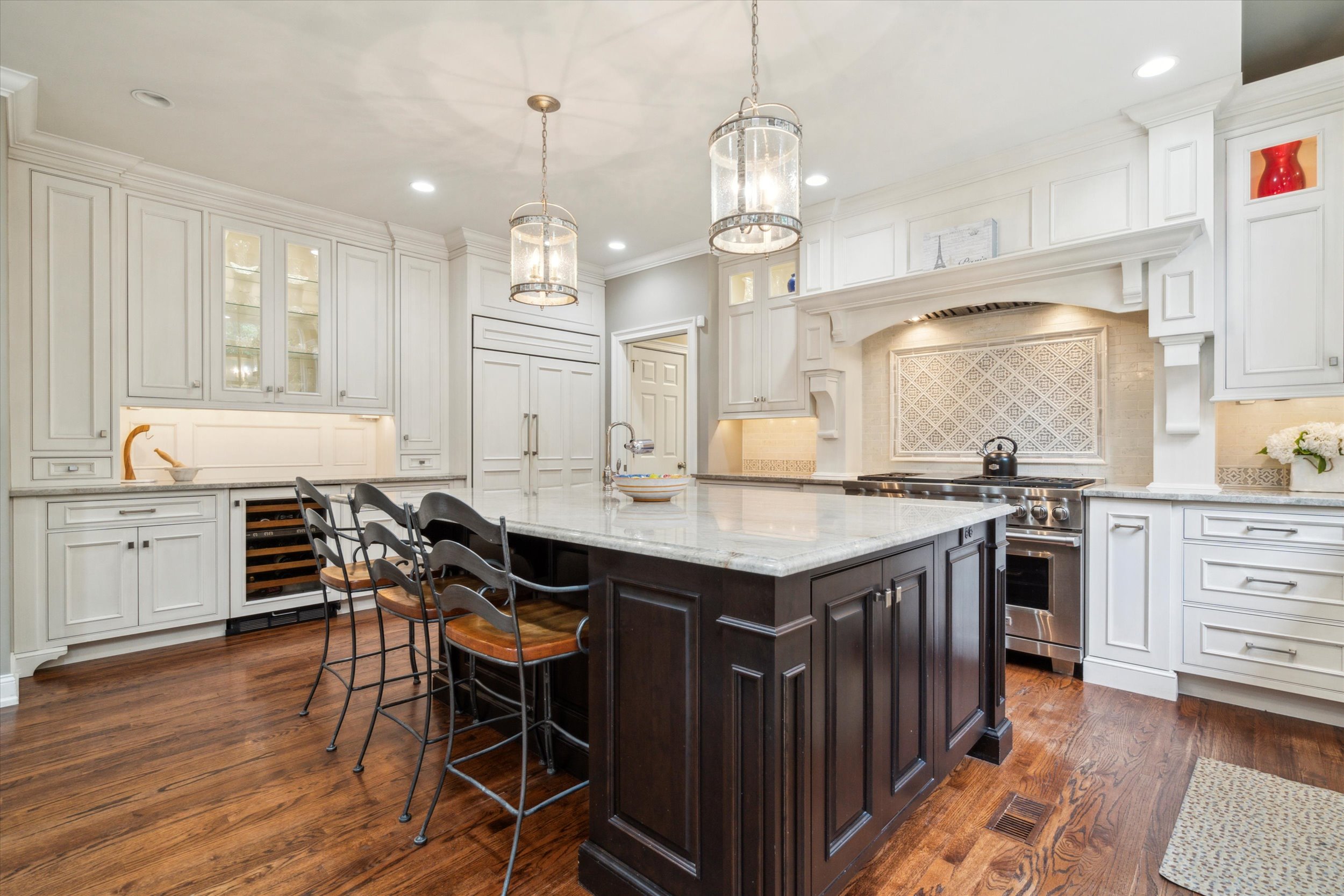 145 Biddulph Road Wayne, PA 19087 - Photo 5 of 39 a open kitchen with stainless steel appliances granite countertop a stove oven a sink dishwasher and white cabinets with wooden floor