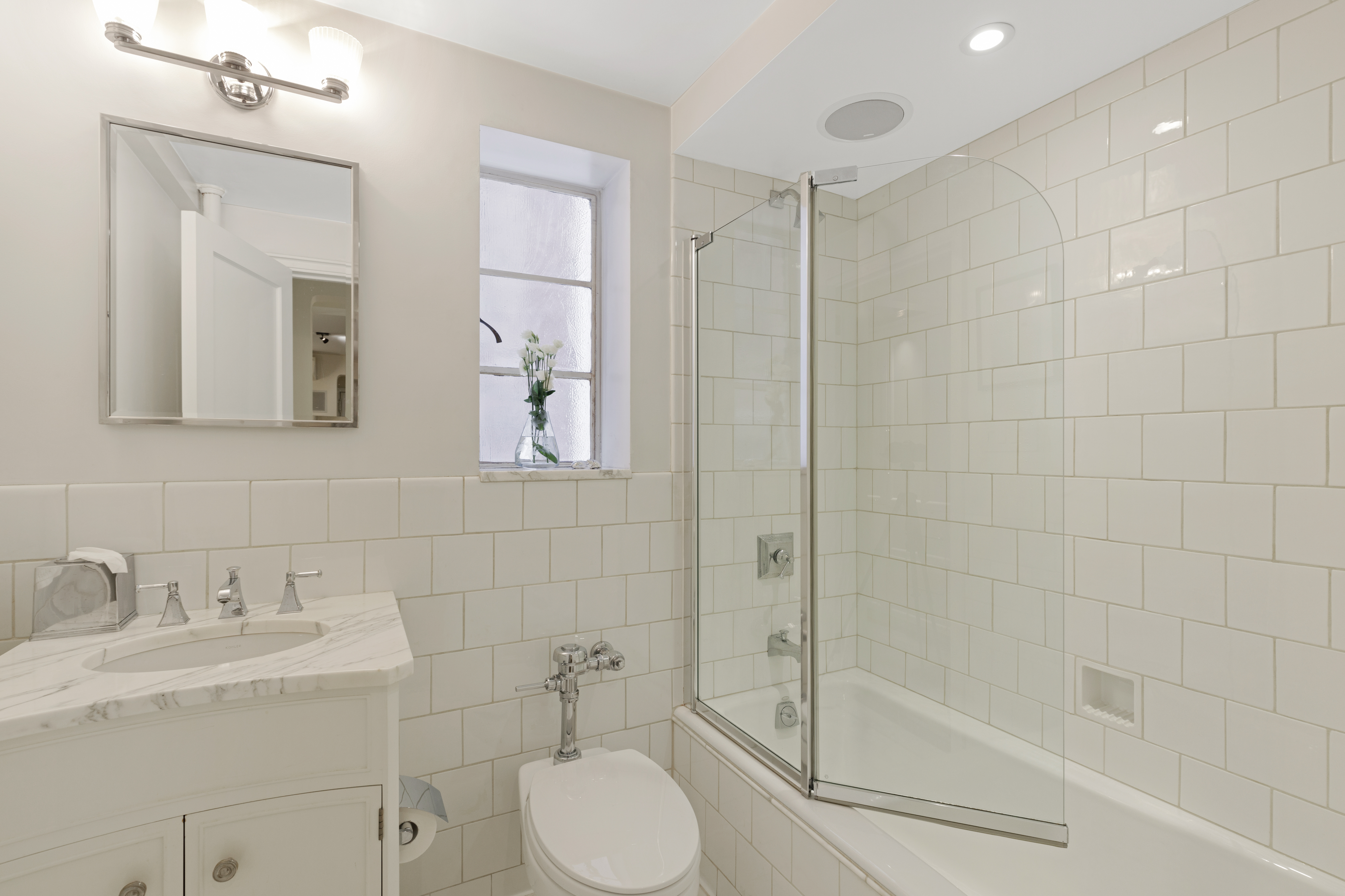 110 East 87th Street, Unit 2C Manhattan, NY 10128 - Photo 10 of 12 a bathroom with a sink toilet and shower