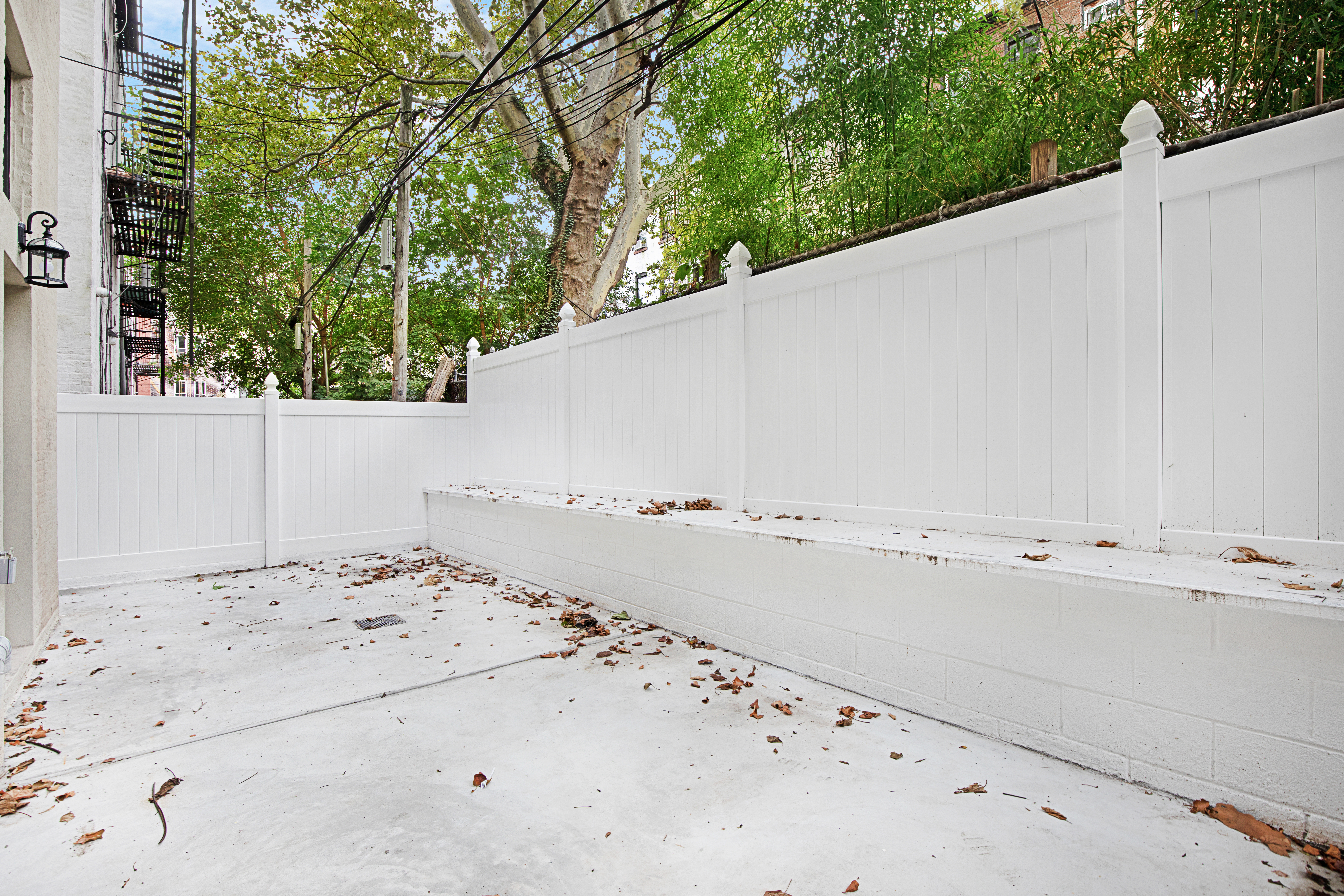 443 Jefferson Avenue, Unit 1L Brooklyn, NY 11221 - Photo 10 of 12 a view of a dry yard with wooden fence