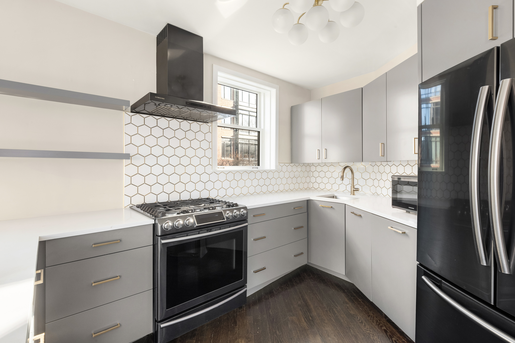 160 West 11th Street, Unit 1 Manhattan, NY 10011 - Photo 8 of 18 a kitchen with stainless steel appliances a stove sink and refrigerator