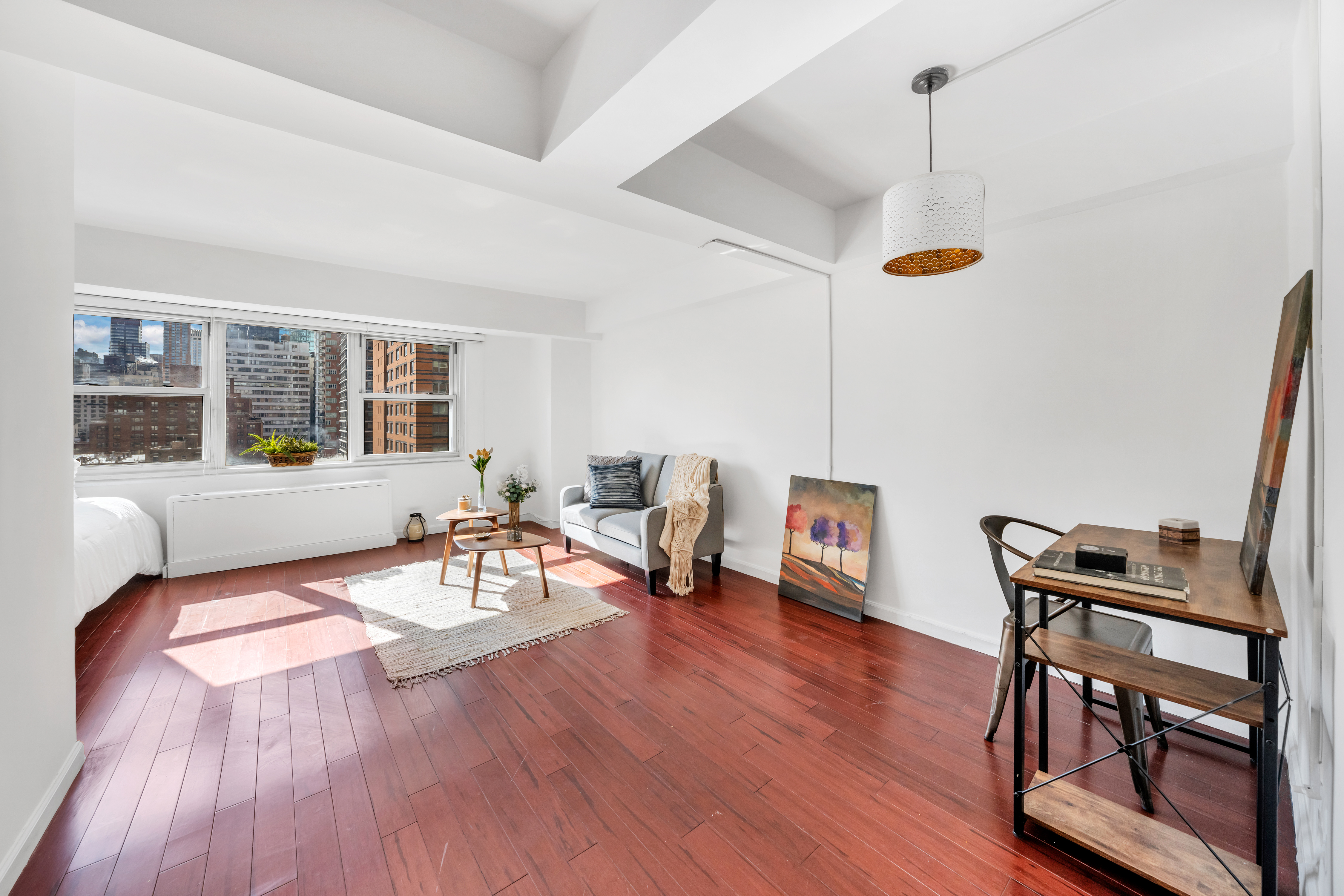 210 East 63rd Street, Unit 11F Manhattan, NY 10065 - Photo 2 of 14 a living room with furniture and a wooden floor