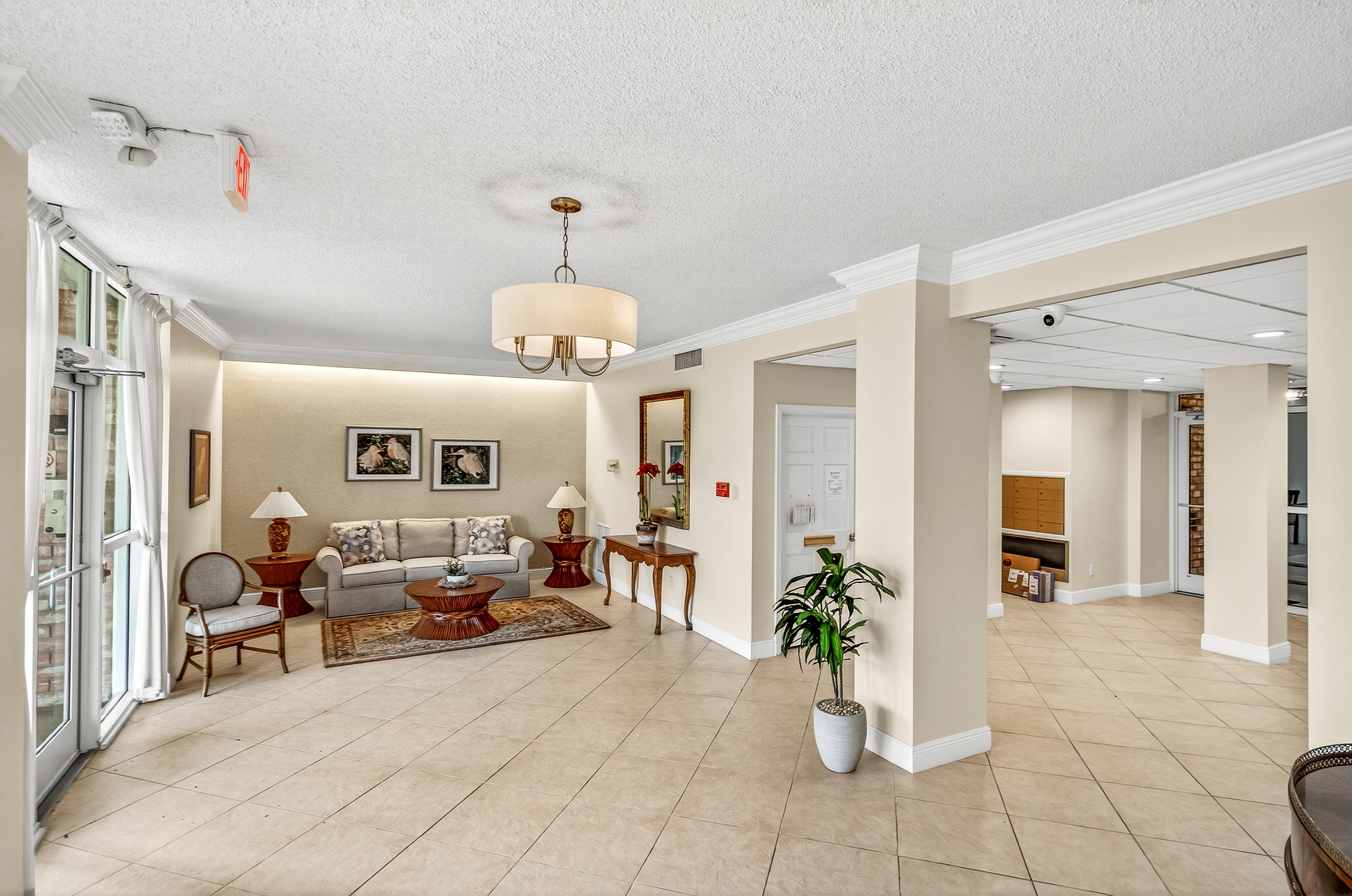 4601 Highway A1a, Unit 102 Vero Beach, FL 32963 - Photo 19 of 29 a living room with furniture and a chandelier