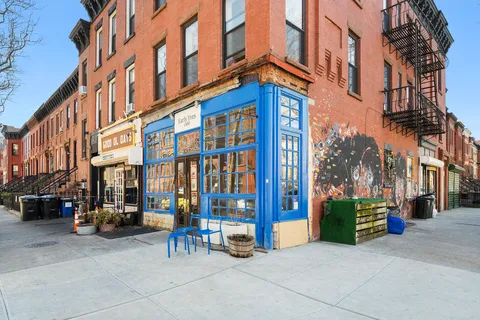 a view of a building with a street sign on a street