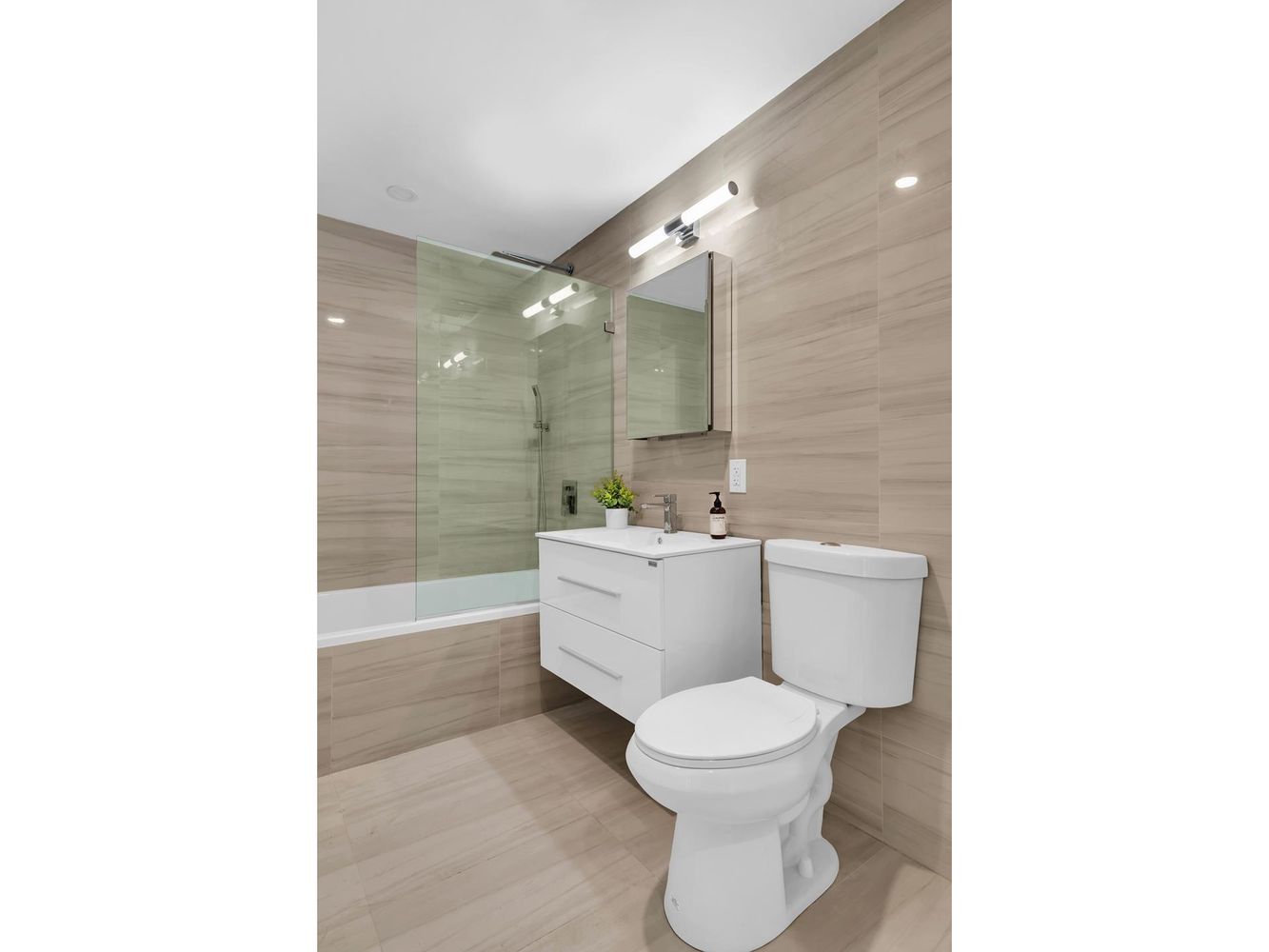 250 Manhattan Avenue, Unit 3F Brooklyn, NY 11211 - Photo 6 of 7 a bathroom with a toilet a sink and bathtub