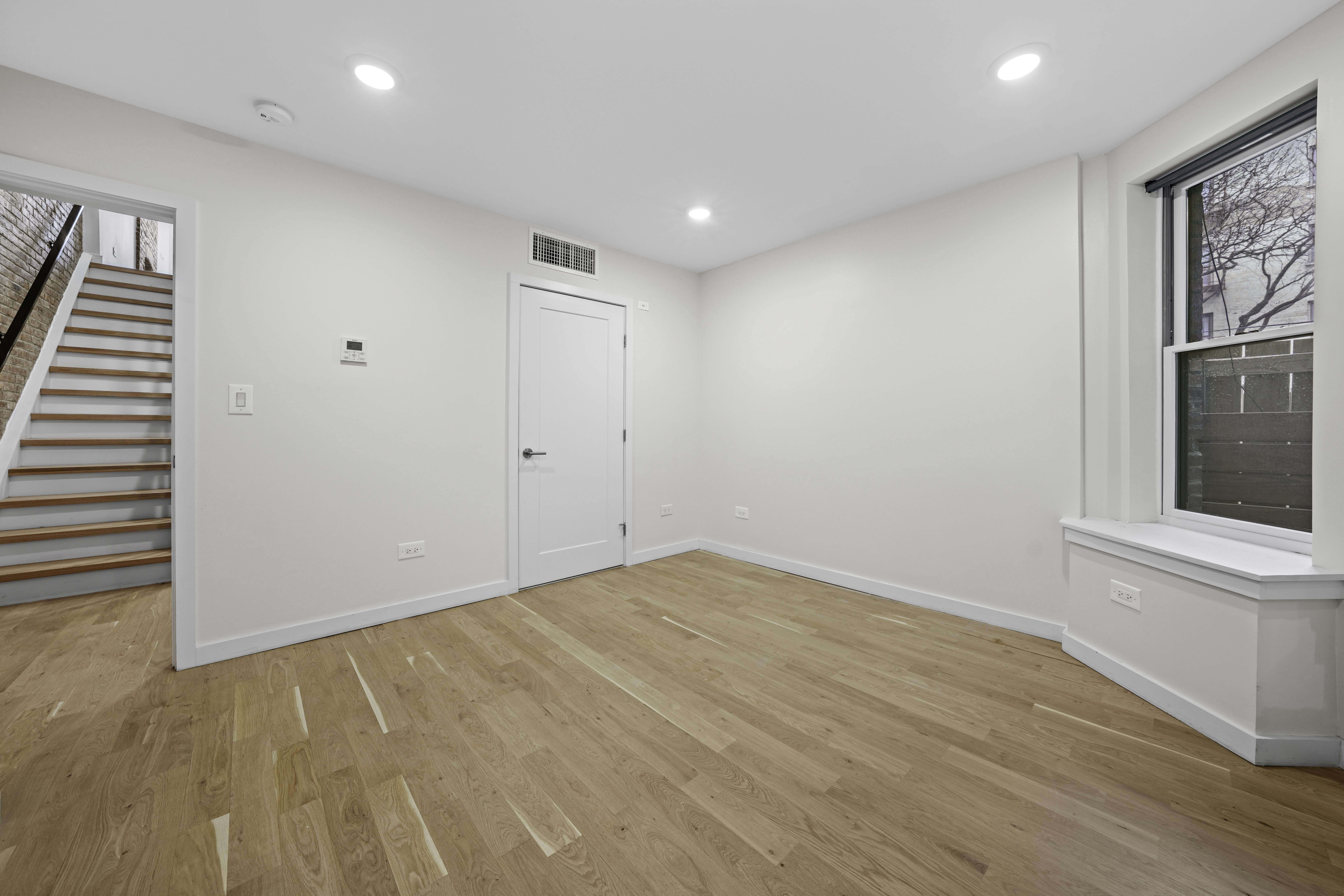 950 St Nicholas Avenue, Unit 1 Manhattan, NY 10032 - Photo 11 of 16 wooden floor in an empty room with a window