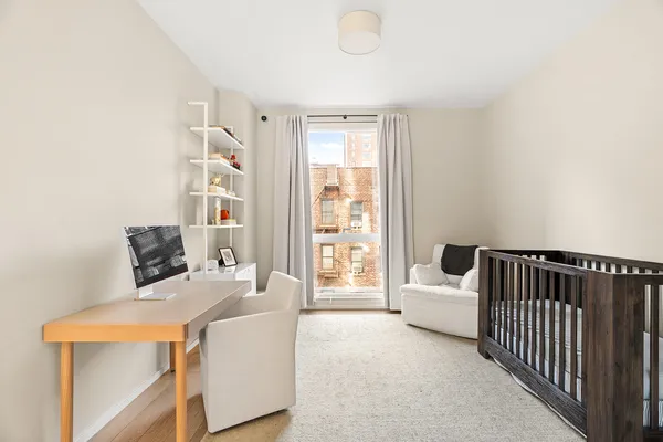 a bed room with a bed and a large window