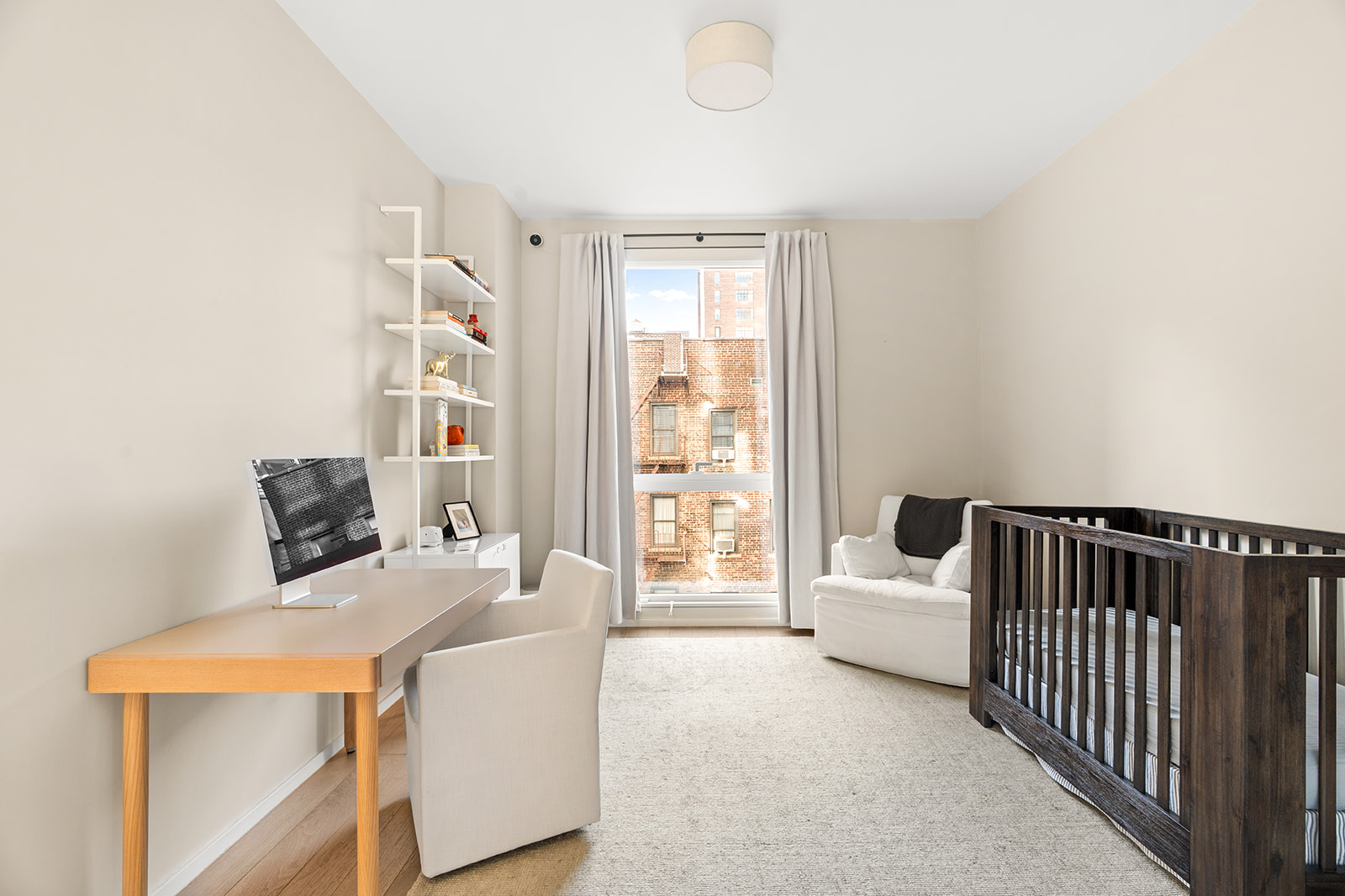 150 East 23rd Street, Unit 5D Manhattan, NY 10010 - Photo 6 of 12 a bed room with a bed and a large window