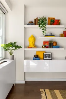 a living room with furniture and flowers