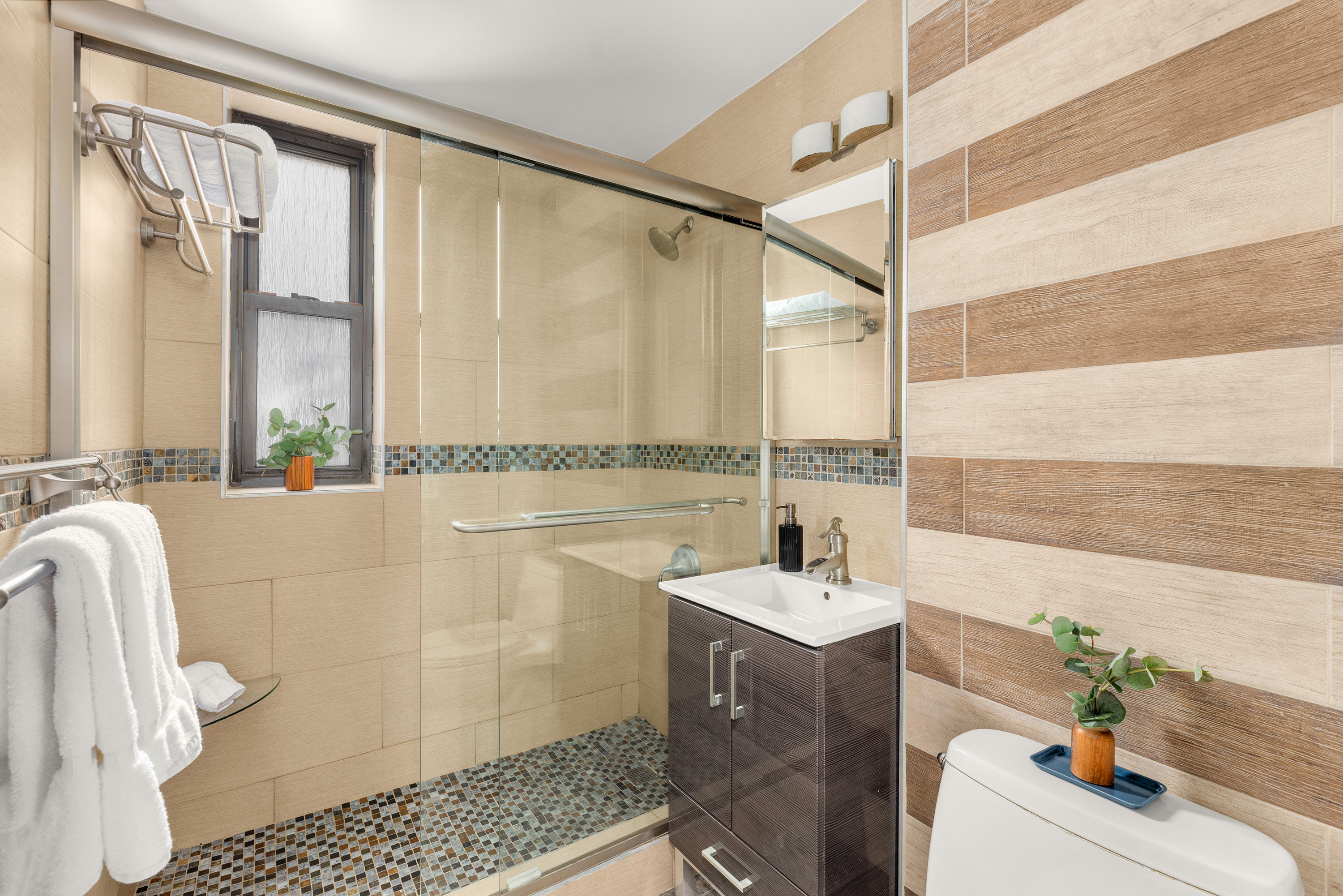 245 East 72nd Street, Unit 8G Manhattan, NY 10021 - Photo 8 of 10 a bathroom with a sink and a mirror