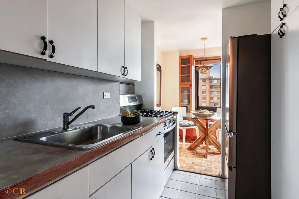 a kitchen with stainless steel appliances granite countertop a sink and a refrigerator