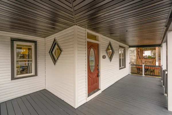 a view of a porch with wooden floors and stairs