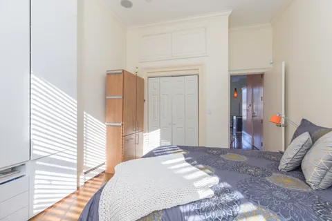 a bedroom with a bed and cabinets