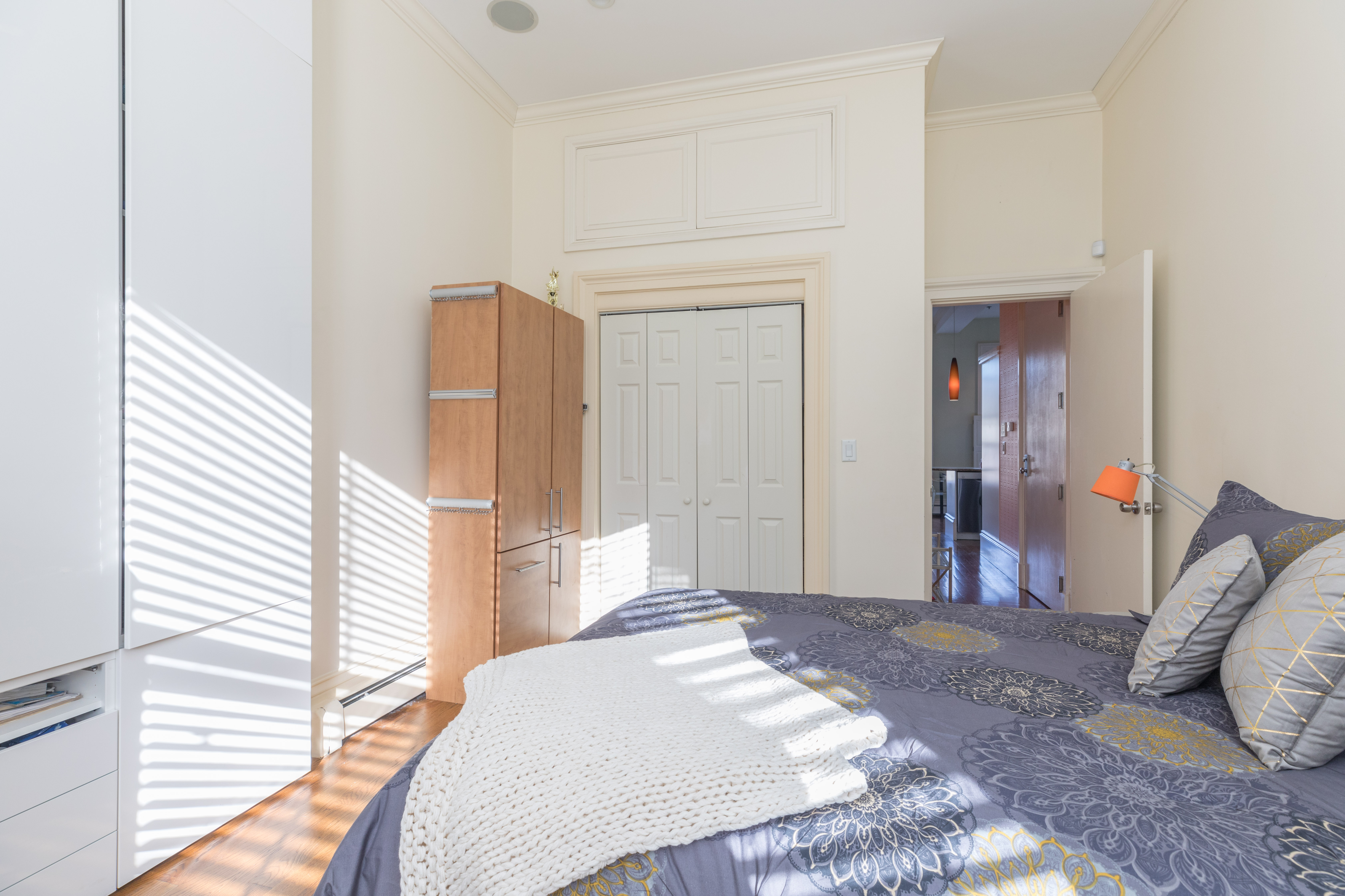 47 Dwight Street, Unit 2 Boston, MA 02118 - Photo 4 of 8 a bedroom with a bed and cabinets