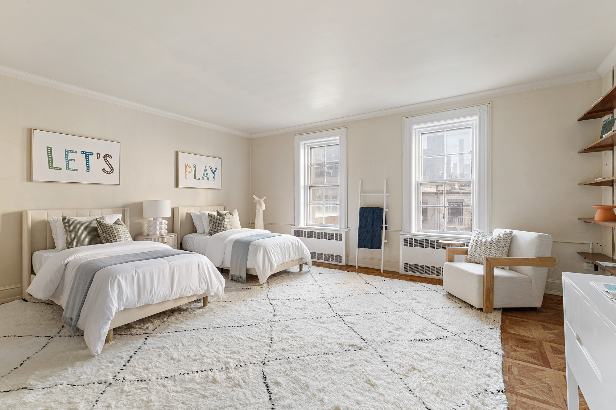10 East 82nd Street Manhattan, NY 10028 - Photo 16 of 22 a spacious bedroom with a bed and glass window
