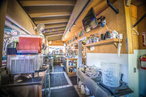 a view of a tables and chairs under an umbrella
