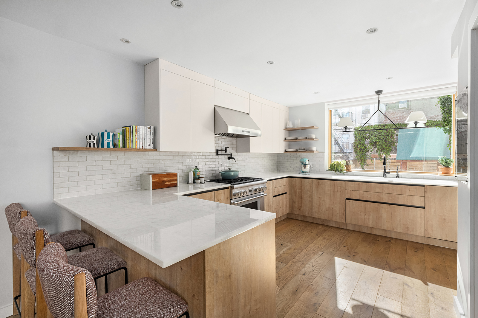 683 Leonard Street Brooklyn, NY 11222 - Photo 4 of 25 a kitchen with granite countertop a sink and white cabinets