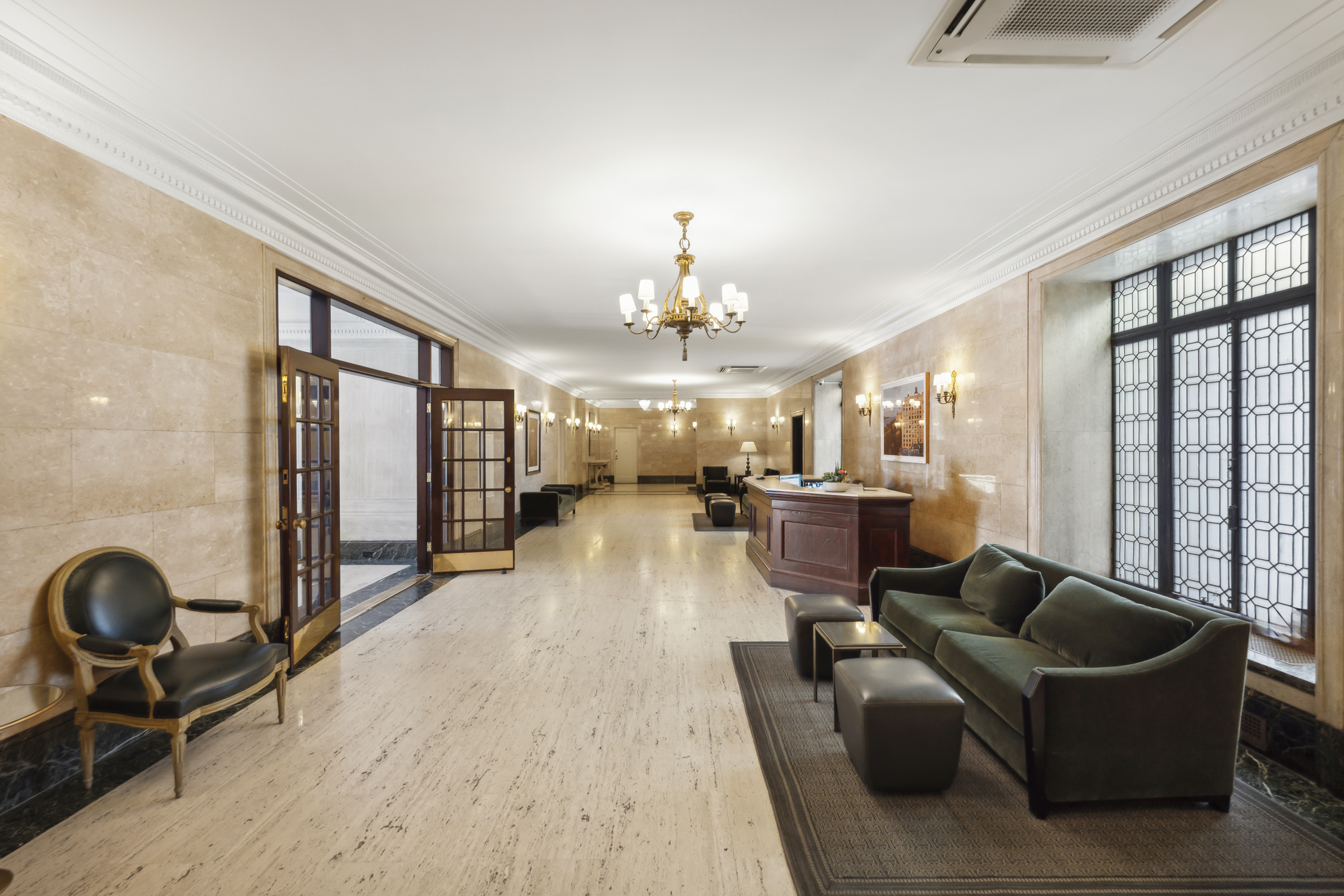 50 Riverside Drive, Unit 5E Manhattan, NY 10024 - Photo 14 of 22 a living room with furniture a chandelier and large window