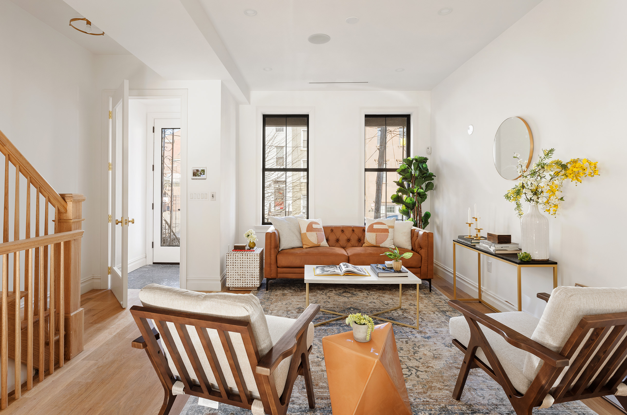 a living room with furniture and wooden floor