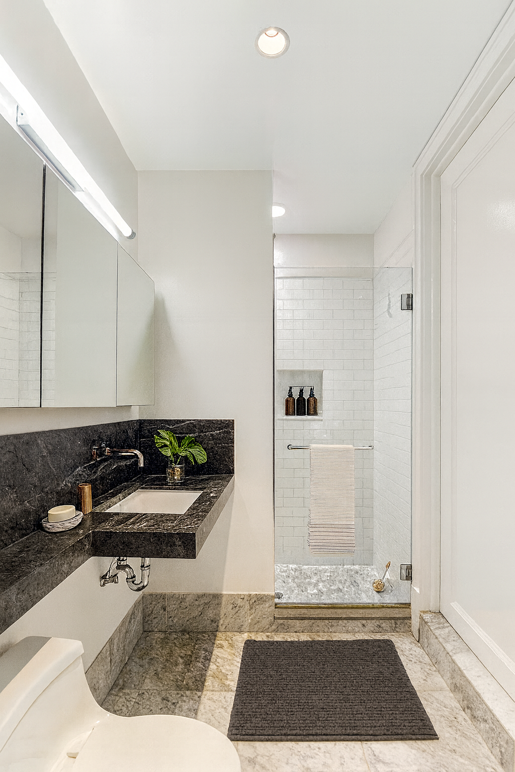 161 Grand Street, Unit PHB Manhattan, NY 10013 - Photo 7 of 11 a room with a couch and a rug