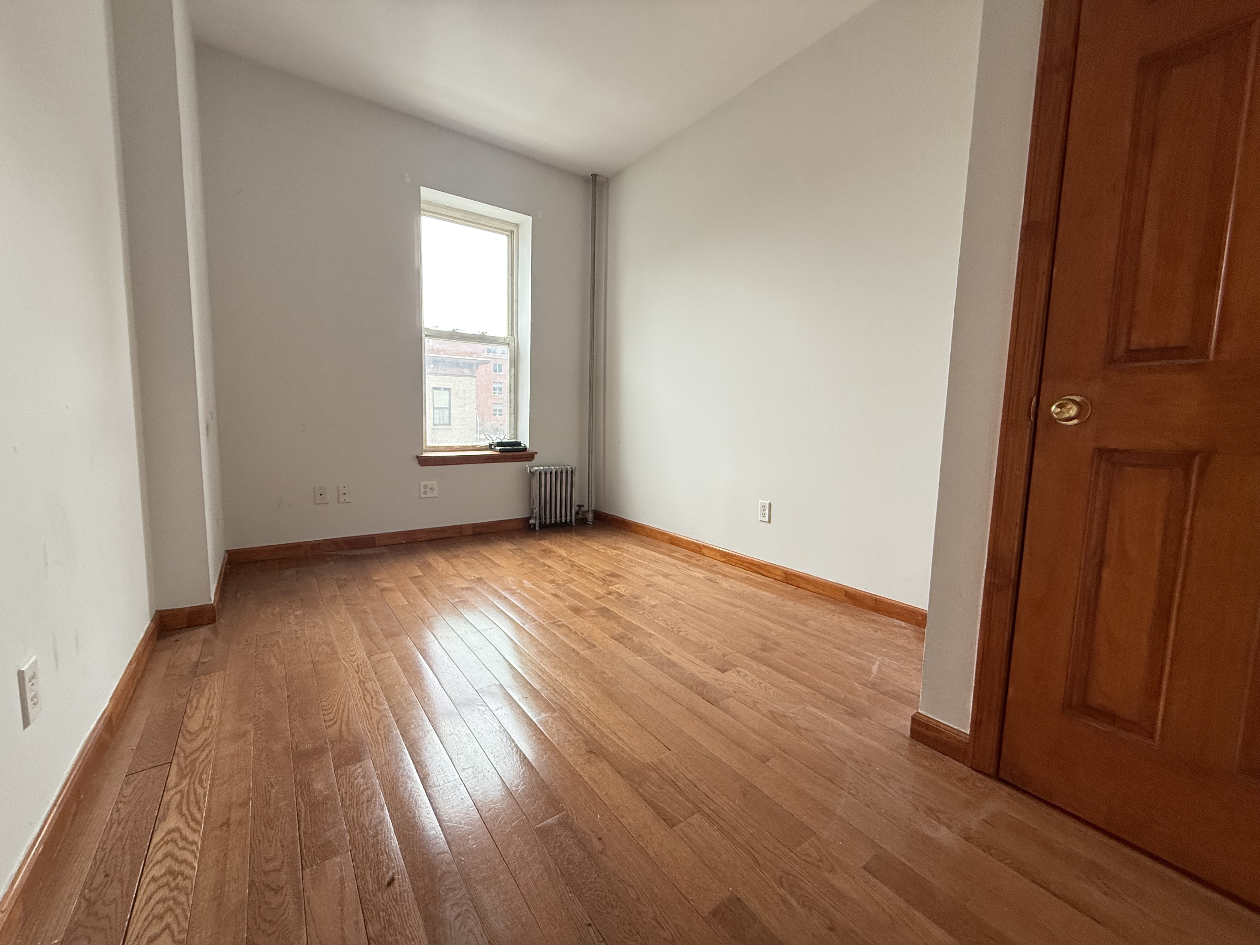 386 Prospect Place Brooklyn, NY 11238 - Photo 6 of 7 an empty room with wooden floor and windows