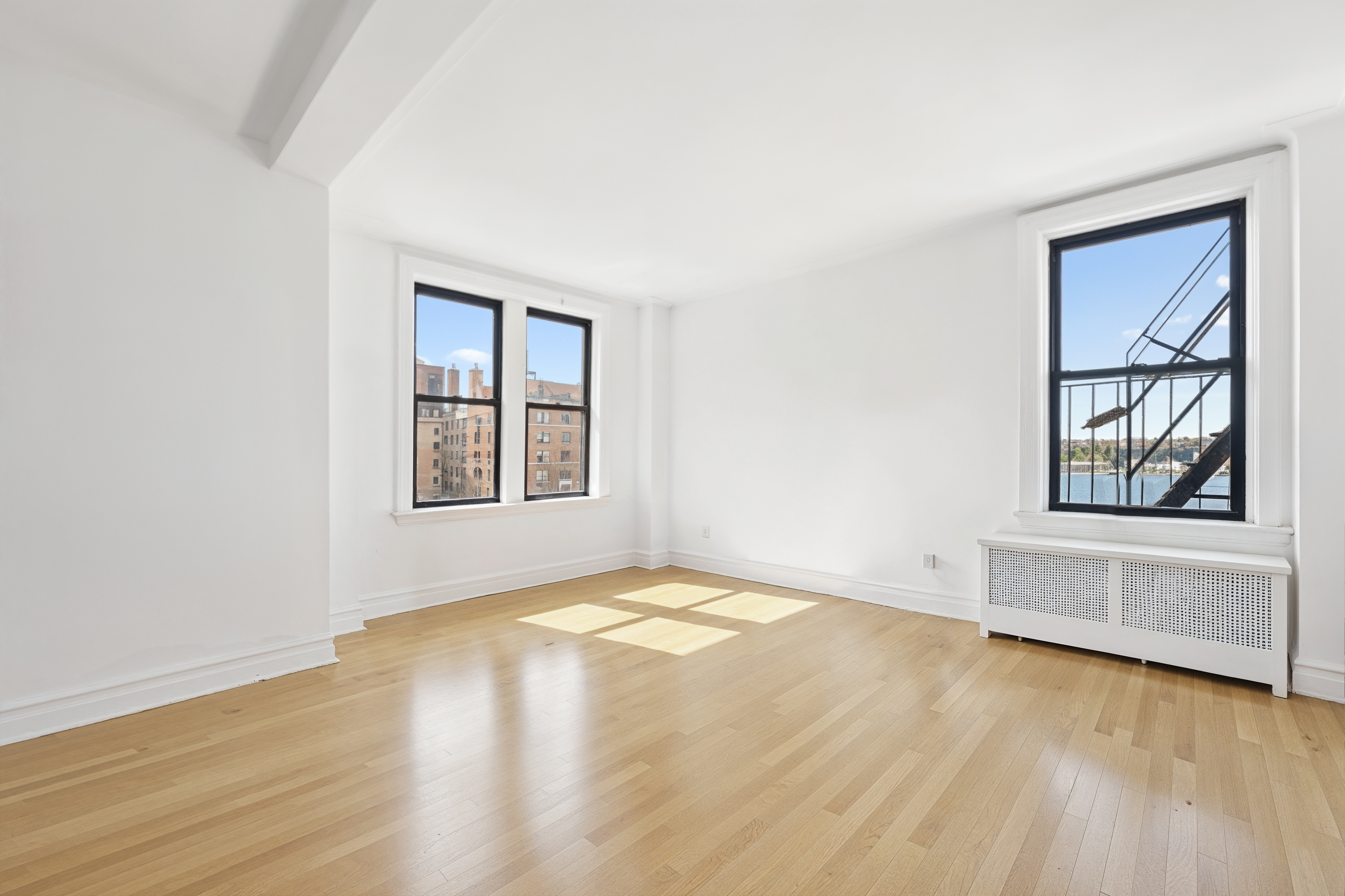 473 West End Avenue, Unit 13D Manhattan, NY 10024 - Photo 2 of 13 an empty room with wooden floor and windows