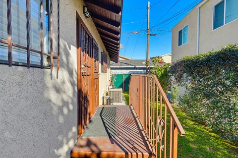 a view of balcony with wooden floor and fence