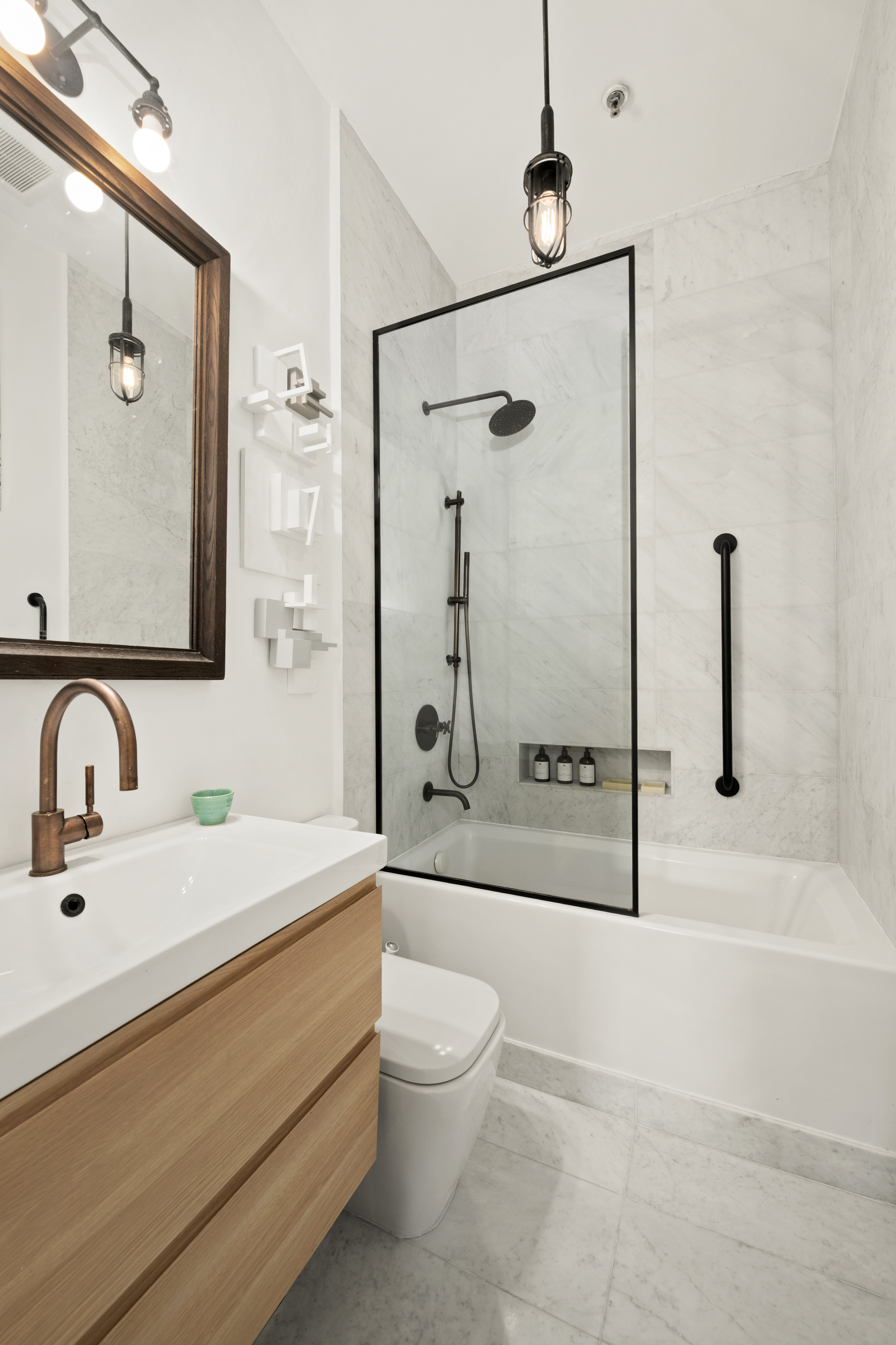 372 Dekalb Avenue, Unit 6E Brooklyn, NY 11205 - Photo 10 of 16 a bathroom with a sink a toilet and shower