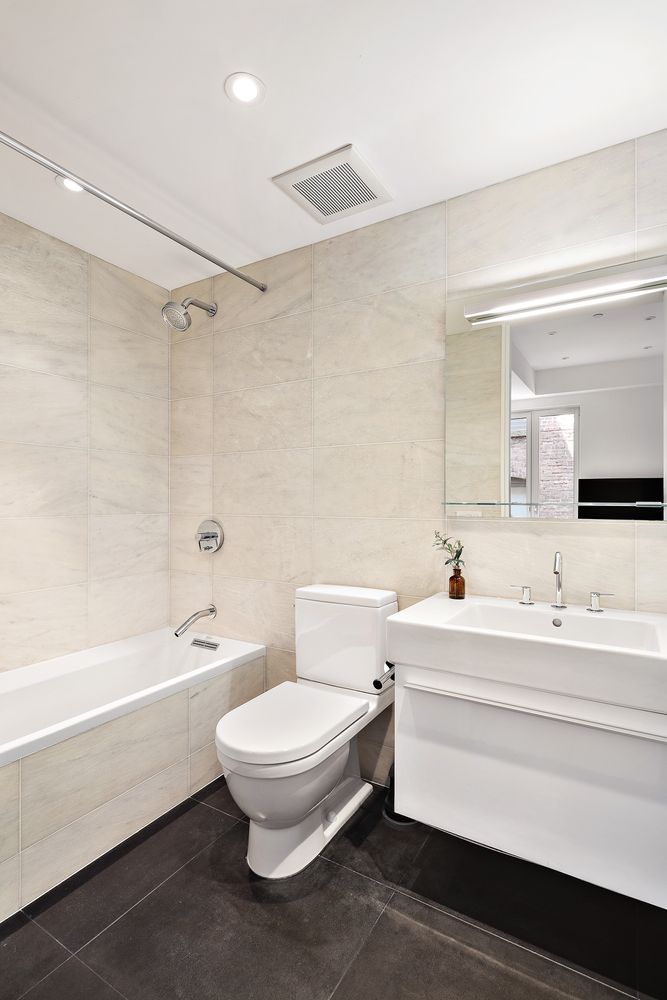 60 Collister Street, Unit 4A Manhattan, NY 10013 - Photo 12 of 21 a bathroom with a toilet a sink and a bathtub