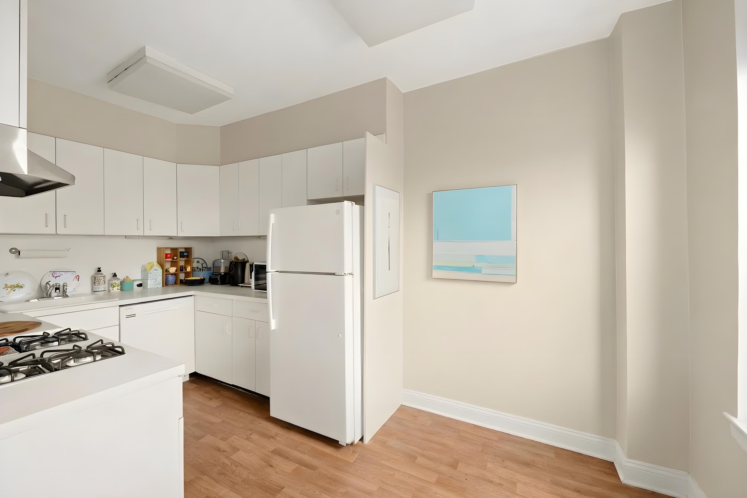110 West 86th Street, Unit 16C Manhattan, NY 10024 - Photo 4 of 12 a kitchen with a refrigerator a stove a microwave and cabinets