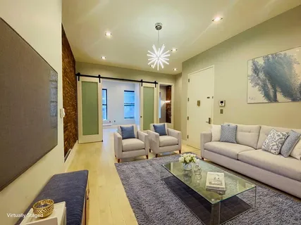 a living room with furniture and a chandelier