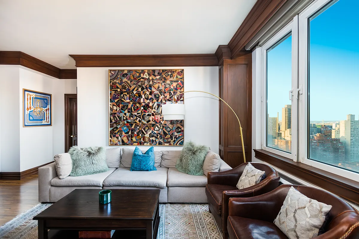 404 East 76th Street, Unit 30C Manhattan, NY 10021 - Photo 2 of 24 a living room with furniture and a floor to ceiling window