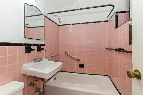 a bathroom with a sink a shower and a mirror