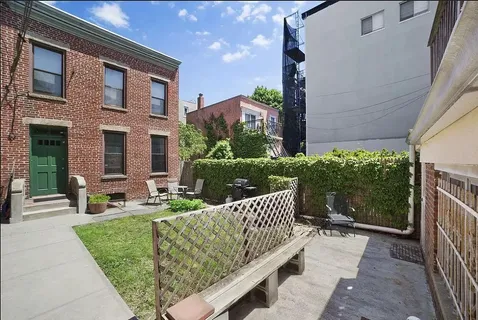 a view of a house with backyard and sitting area