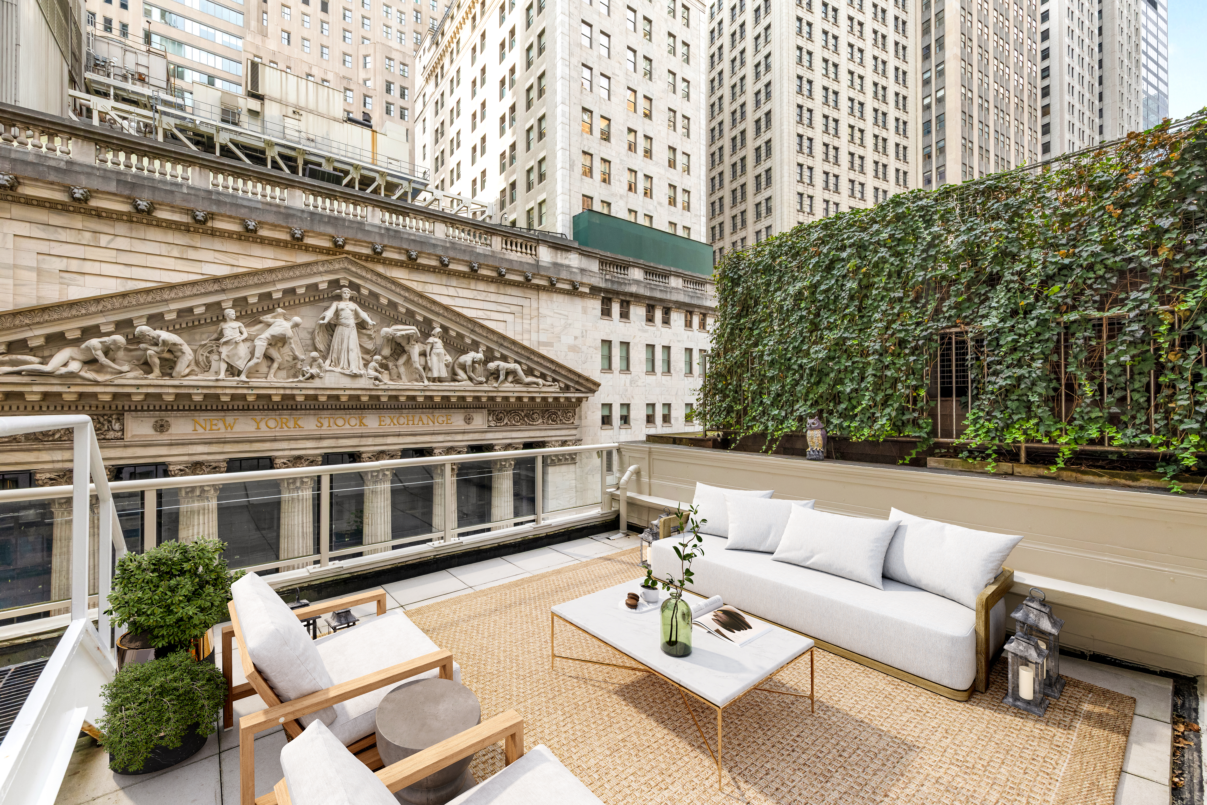 15 Broad Street, Unit 710 Manhattan, NY 10005 - Photo 8 of 11 a view of a building with couches and a table