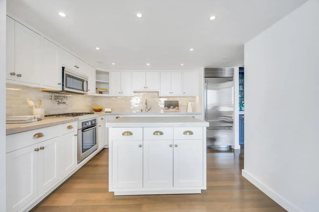 a kitchen with stainless steel appliances granite countertop a sink and cabinets