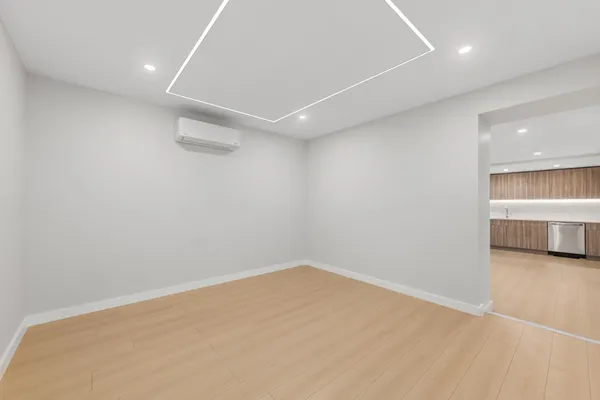an empty room with a empty space and windows