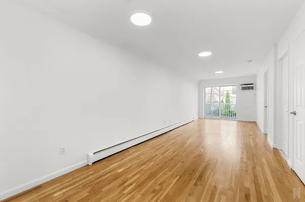 a view of an empty room and wooden floor
