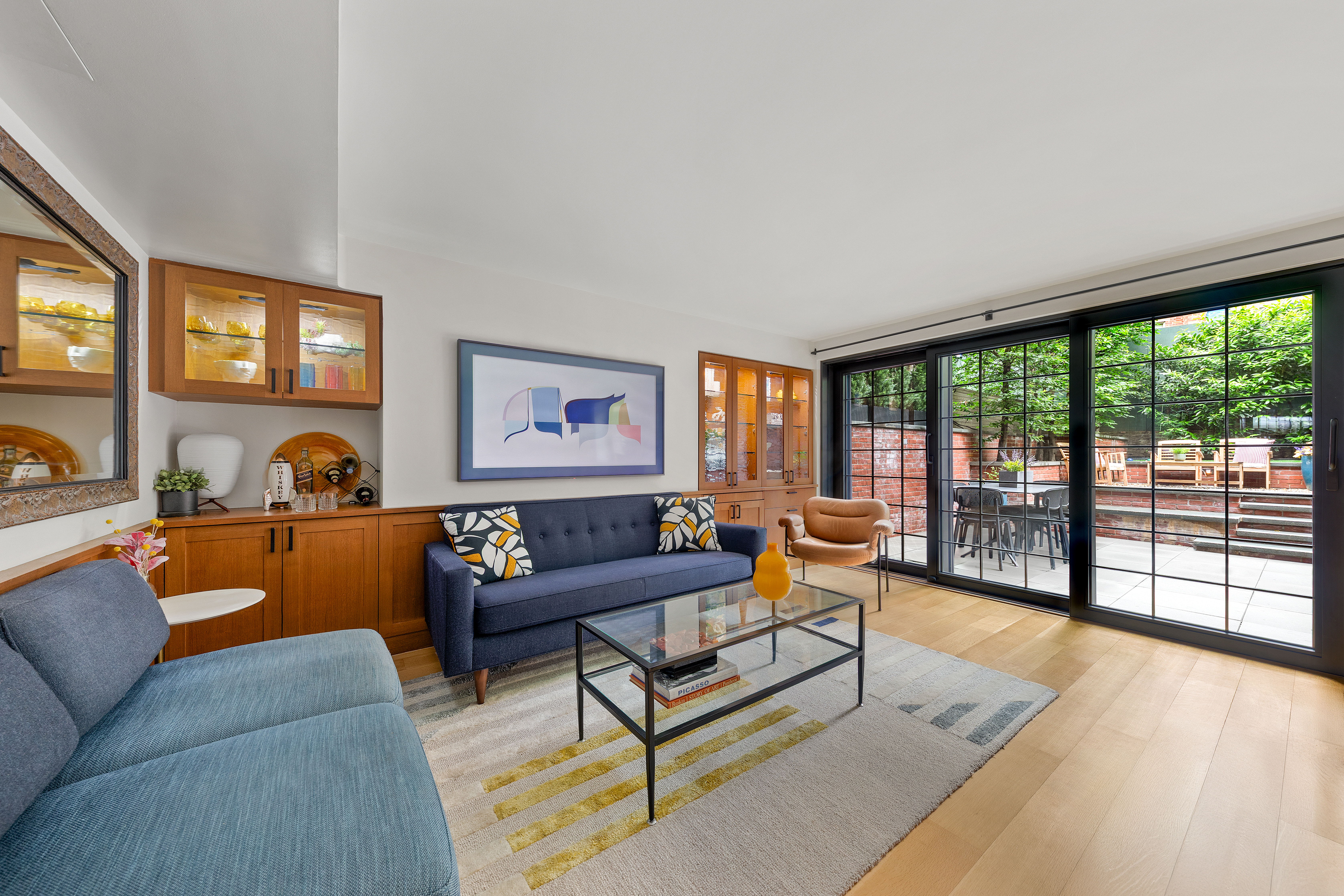 21 Bethune Street, Unit GARDEN Manhattan, NY 10014 - Photo 3 of 12 a living room with furniture and a floor to ceiling window