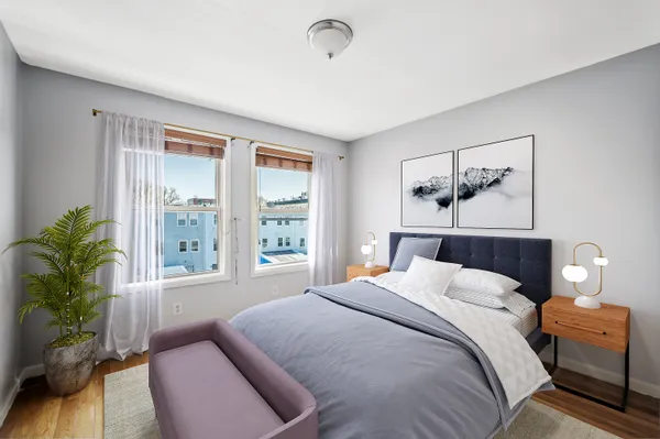 a bedroom with a large bed and a window