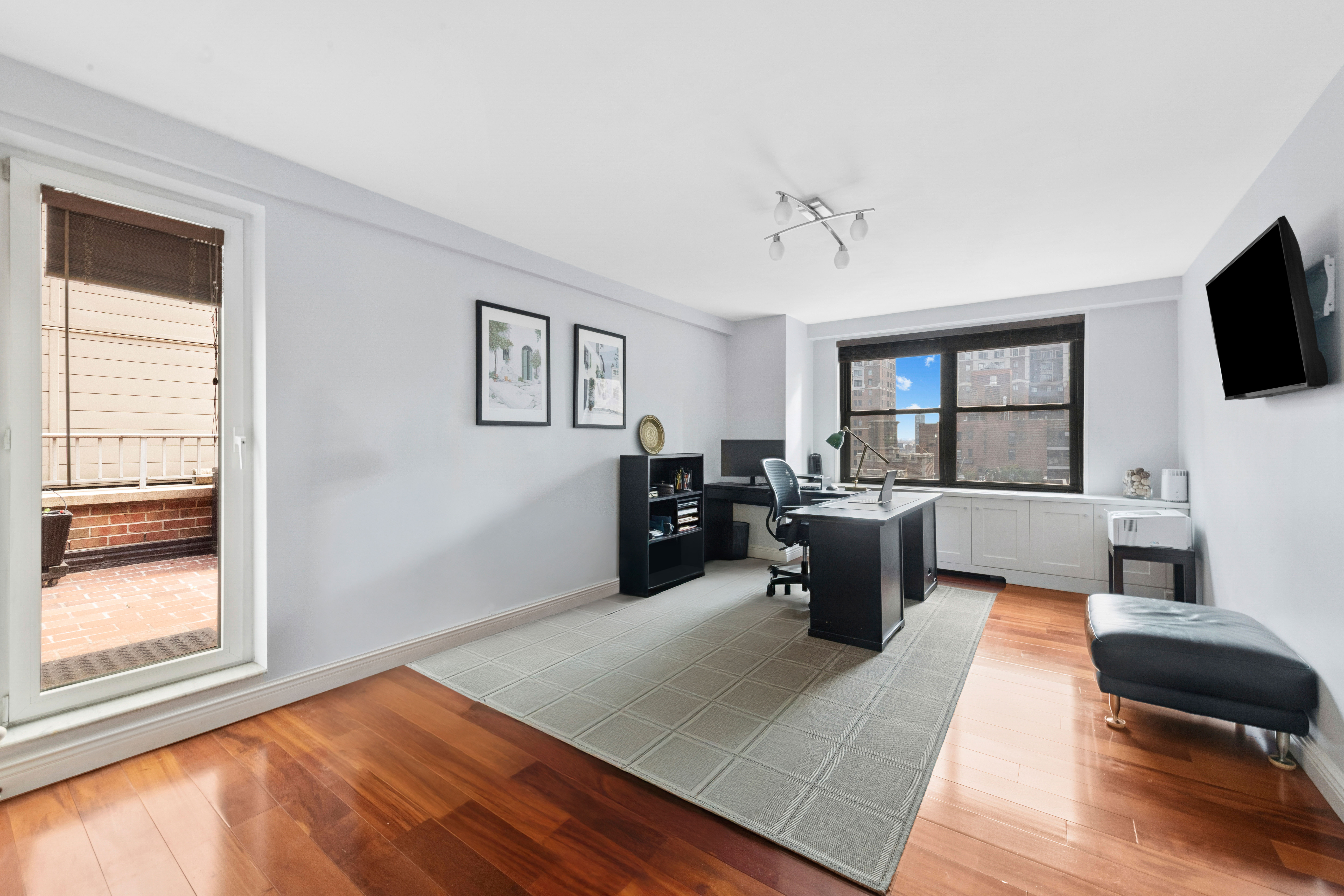 305 East 40th Street, Unit 19CD Manhattan, NY 10016 - Photo 8 of 16 a living room with furniture fireplace and flat screen tv