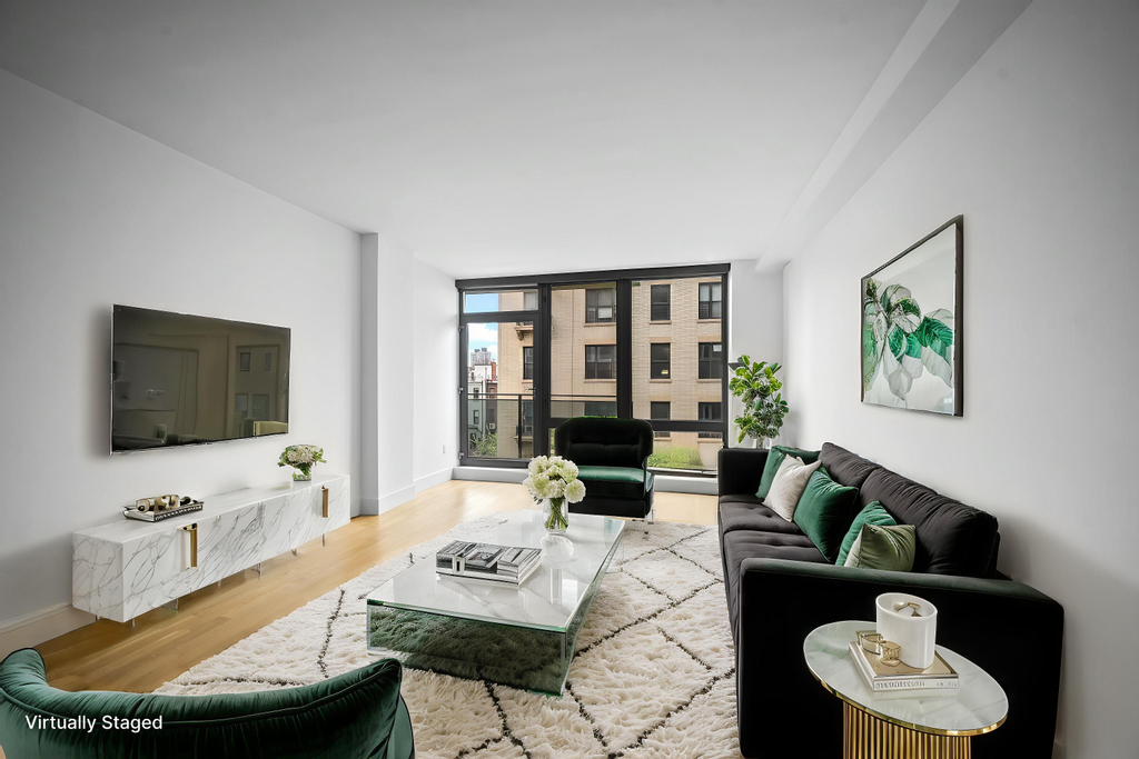 117 West 123rd Street, Unit 5D Manhattan, NY 10027 - Photo 1 of 18 a living room with furniture and a flat screen tv