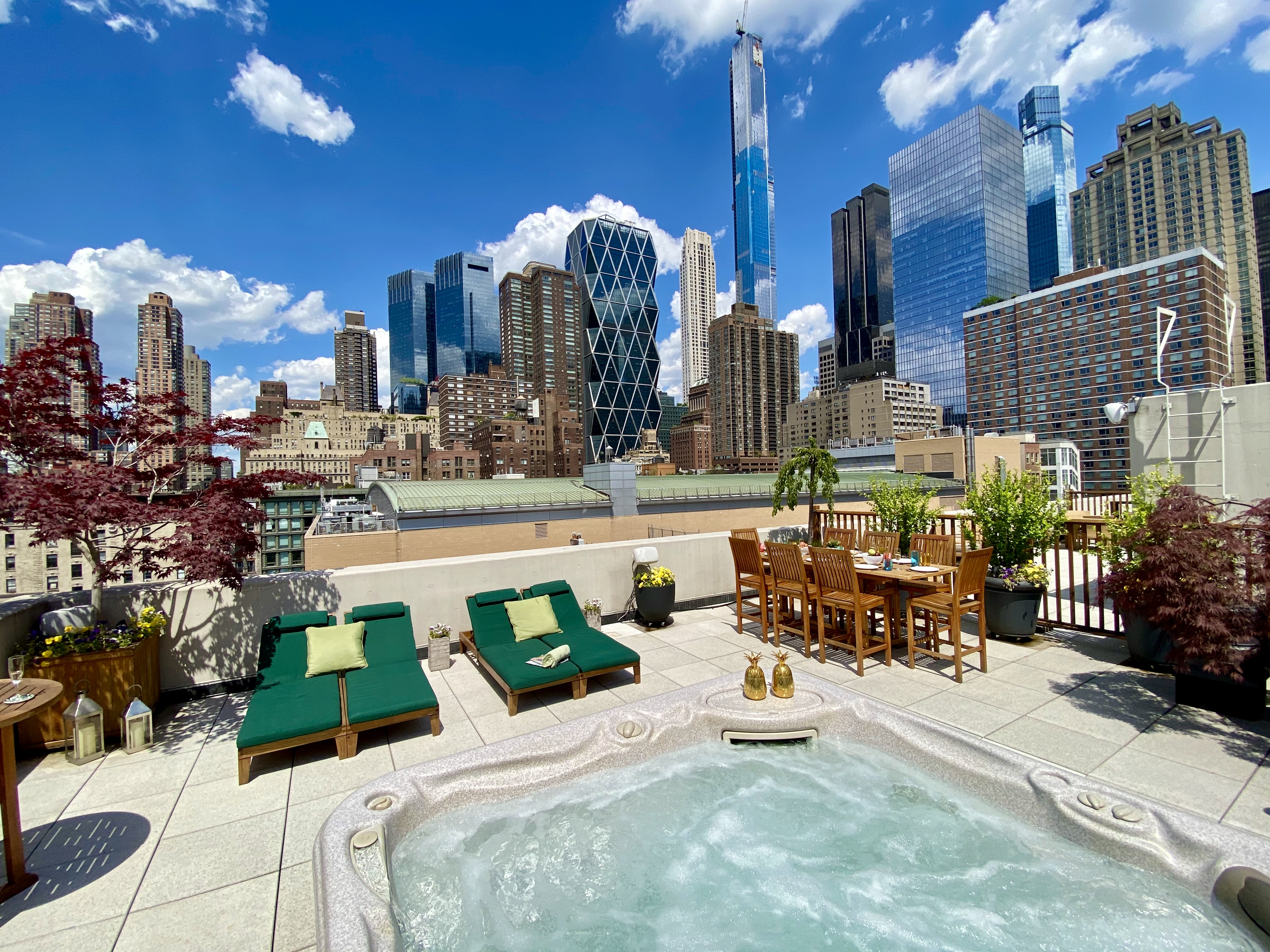 350 West 53rd Street, Unit PHB Manhattan, NY 10019 - Photo 1 of 34 a view of a patio with couches table and chairs and potted plants