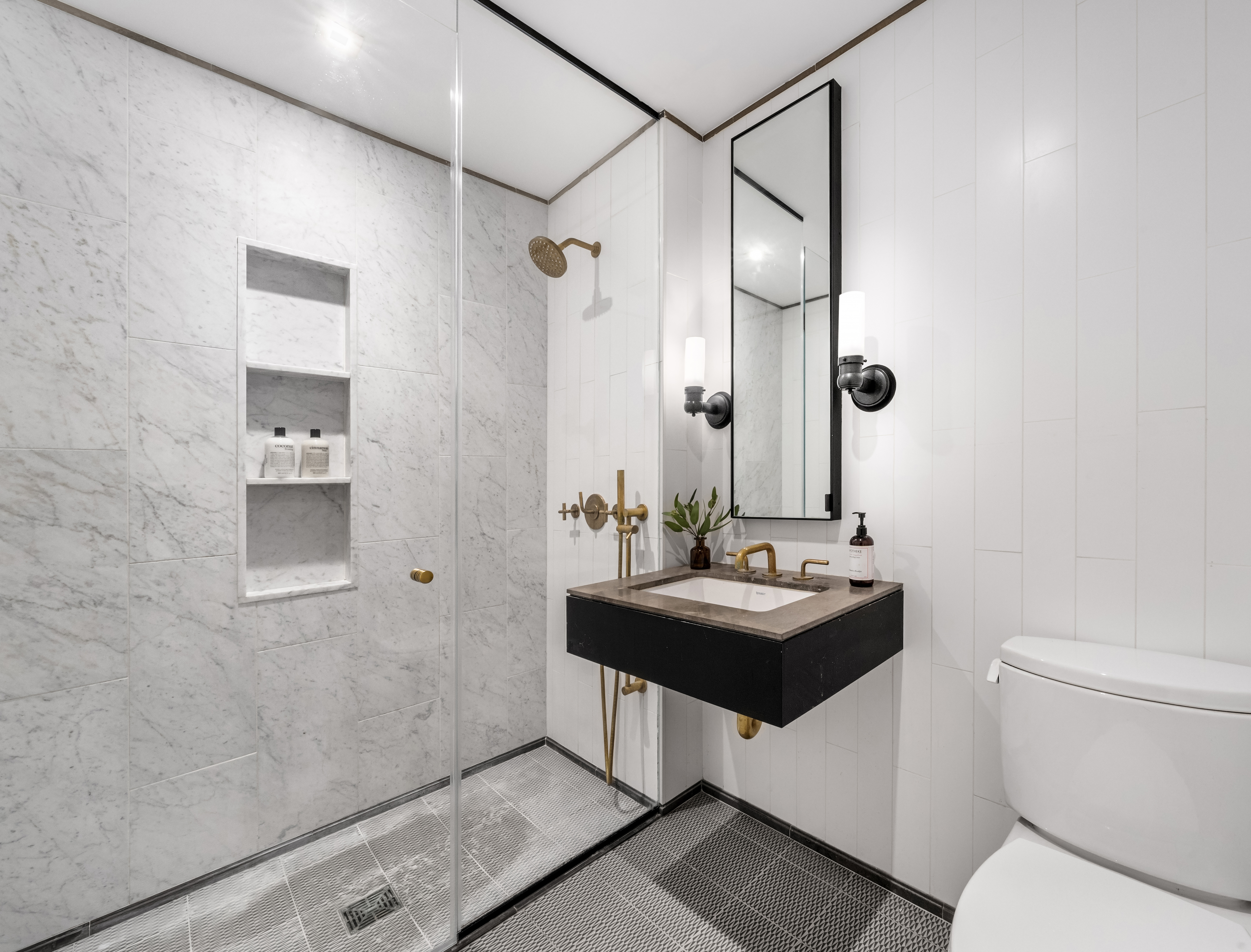 50 Clinton Street, Unit 4A Manhattan, NY 10002 - Photo 7 of 12 a bathroom with a sink and a mirror