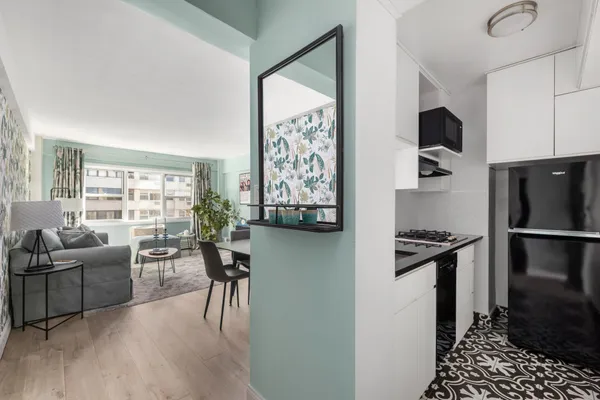a kitchen with stainless steel appliances granite countertop a refrigerator stove and sink