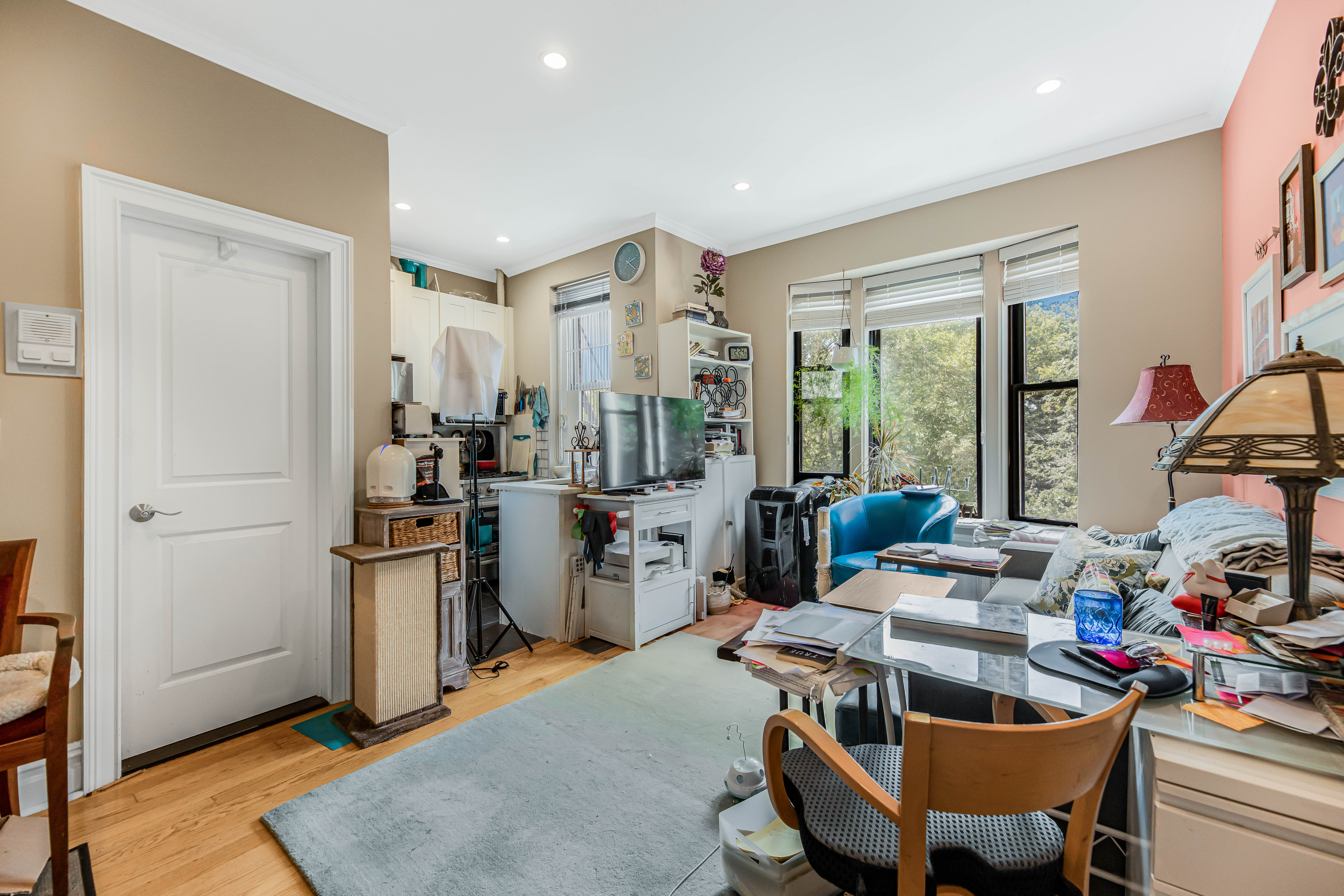 660 Riverside Drive, Unit 4J Manhattan, NY 10031 - Photo 7 of 7 a work room with furniture a large window and a rug